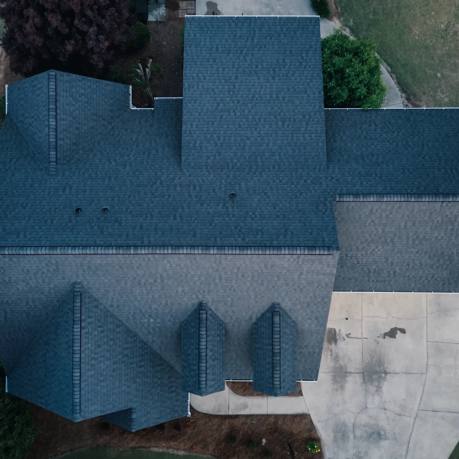 Aerial view of a completed new charcoal architectural shingle roof