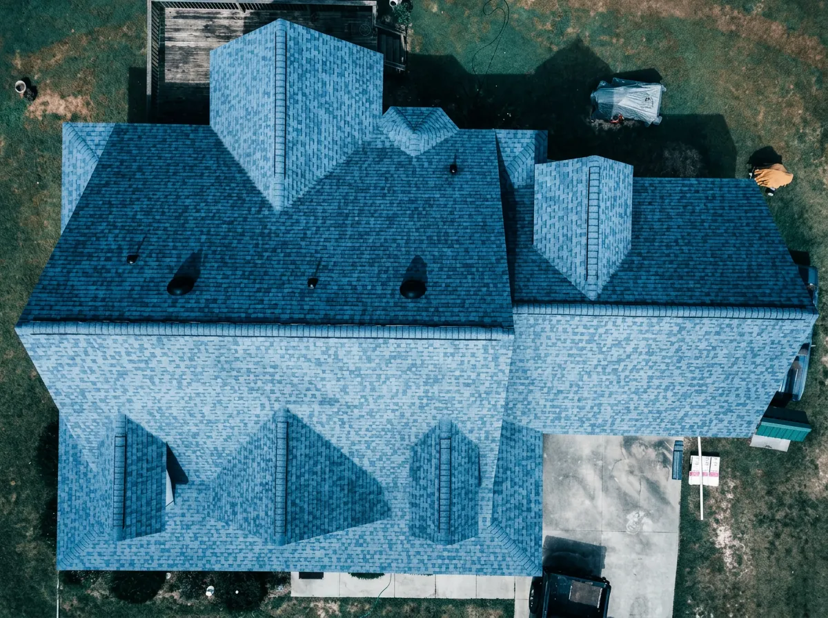 Top-down aerial view of a large slate-blue architectural shingle roof